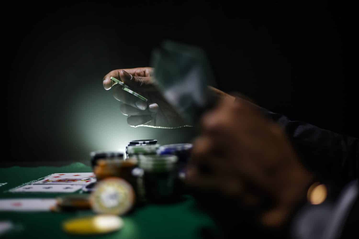 person playing poker in a dark room